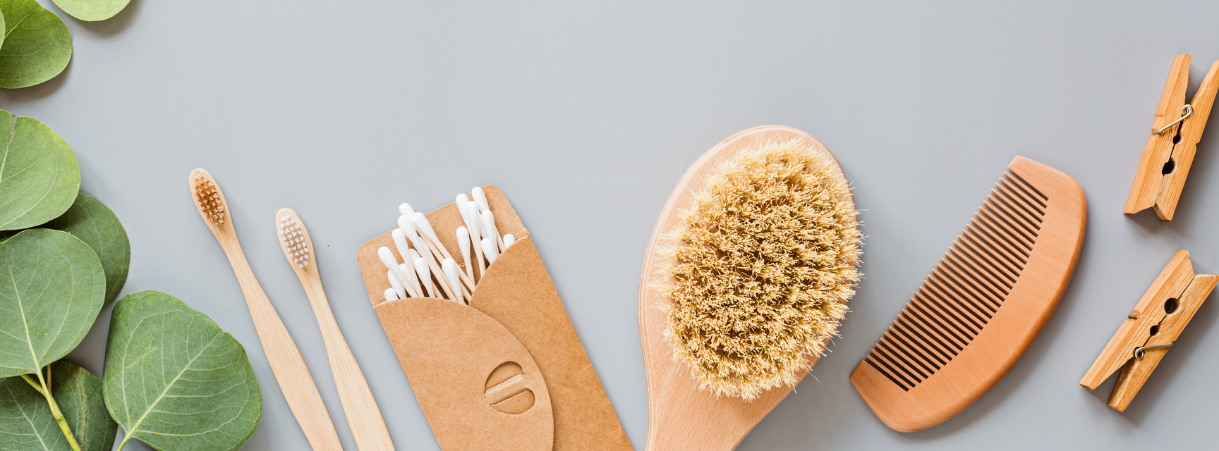 Composition of Wooden Comb, Brush, Toothbrush and Cotton Buds Flatlay